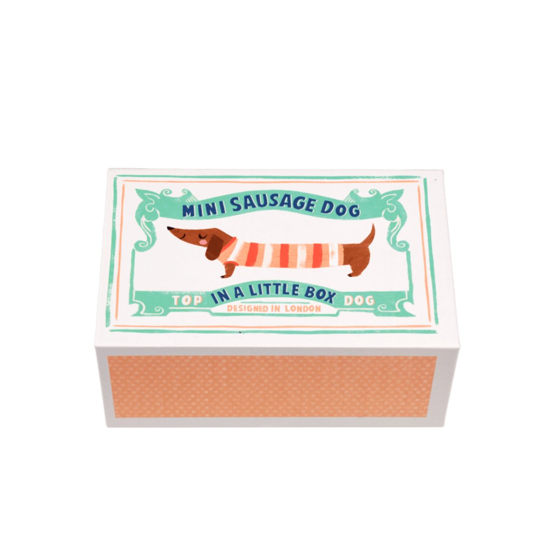 mini sausage dog plush toy in a little box